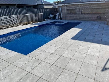 natural stone pavers, outdoor pavers, pool coping, pool surround ideas, pool surrounds, swimming pool tiling, swimming pool paving, paver stones, pool landscaping